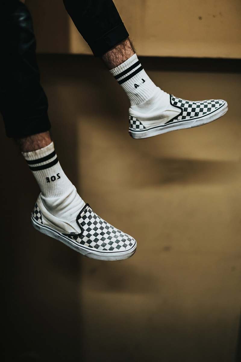 los angeles person wearing white-and-black checked slip-on shoes shoe